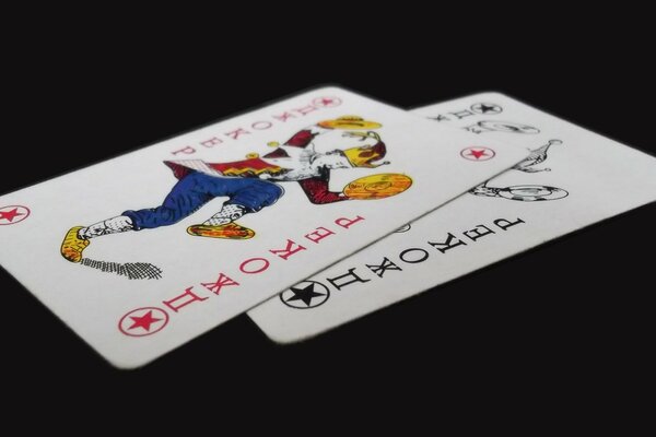 There are two joker cards on a black background