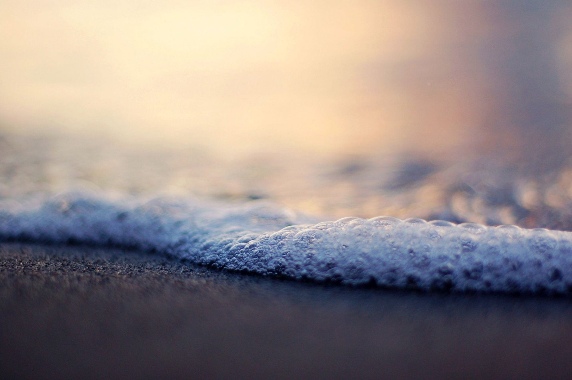 foam bubbles blur wave sand beach shore water sea