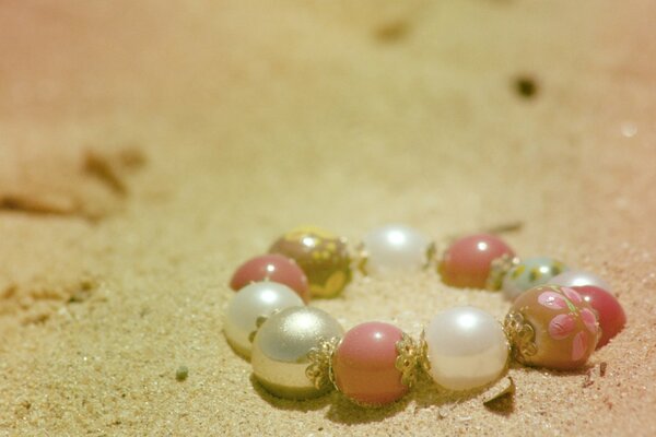 A bead bracelet lying on the sand