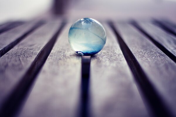 A glass ball on a bench