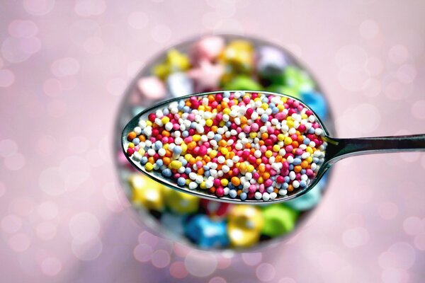 Spoon with colorful sweet dragees