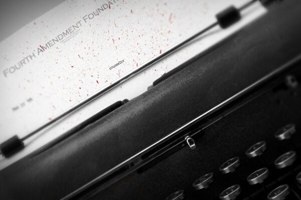 Image of a typewriter with buttons and a letter