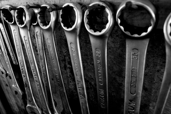 A set of wrenches on nails