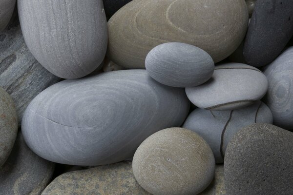 Gray round stones of different sizes close-up
