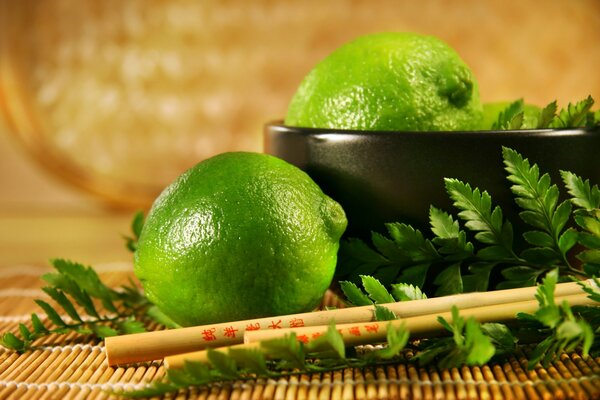 Lime and greens with Chinese chopsticks in a bowl