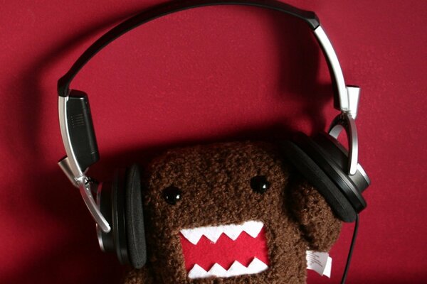 A plush monster wearing headphones