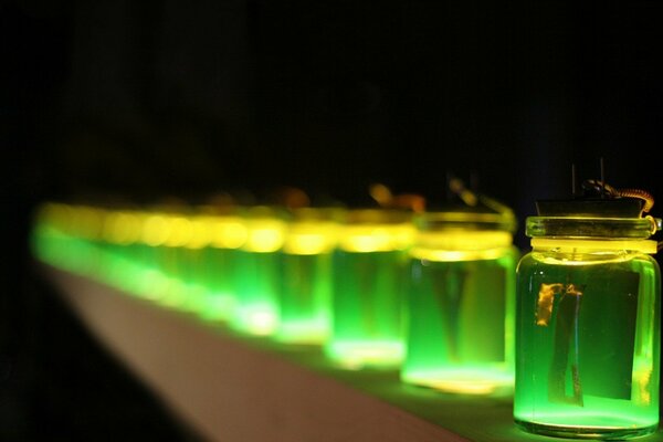 Jars of green liquid. Glow effect