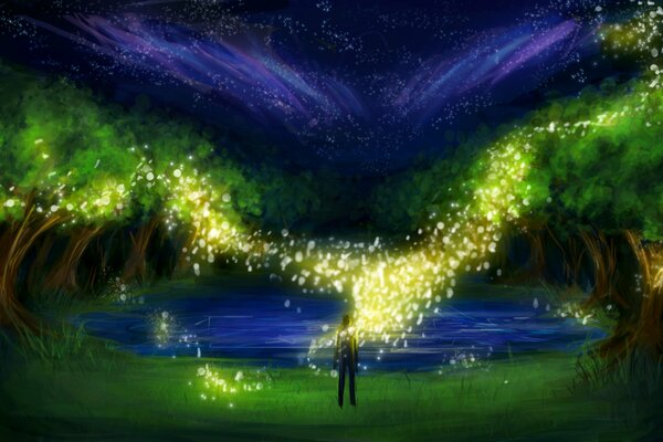 A man stands by the lake in the light of firefly sparks