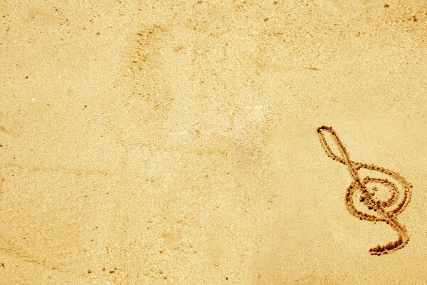 Drawing of a treble clef in the sand