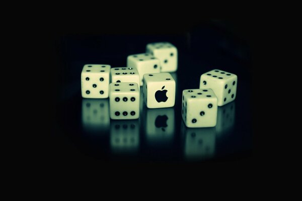 Playing dice with the APPLE logo on a black background