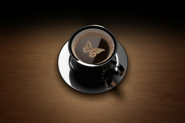 A cup of coffee with a butterfly on the foam