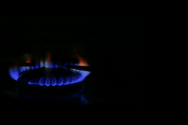 Dark background with gas burner on