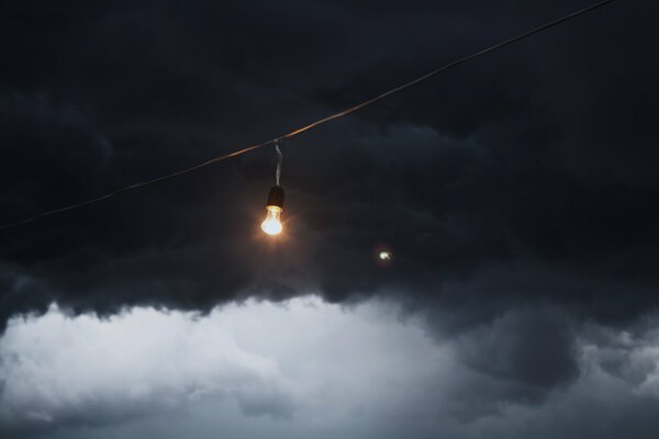 A light bulb against a cloudy sky