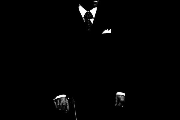 SILHOUETTE OF A MAN IN A TUXEDO ON A BLACK BACKGROUND