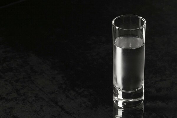 A glass of water on a black background