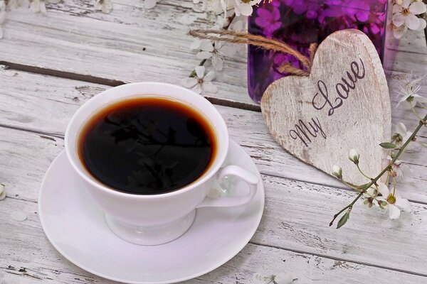 A cup of coffee on a beautiful background of a table and flowers