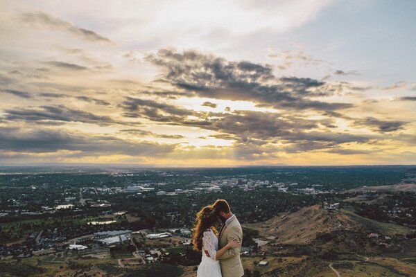 The bride and groom in love on the background of the city