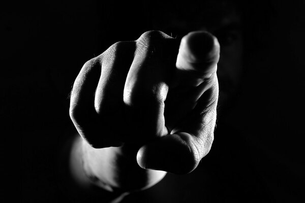 Pointing hand gesture on a black background