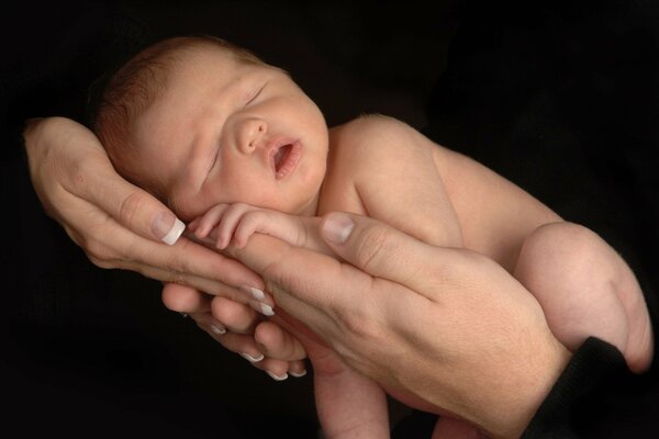 A small child in the arms of his parents