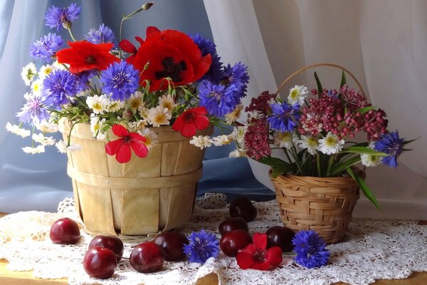 Beautiful still life: baskets with flowers and berries