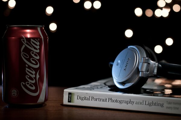 Headphones on the background of a book with a jar