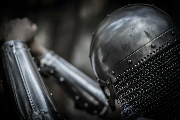 A warrior in metal armor, wearing a helmet