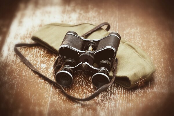 Un viejo binocular descansa sobre un tocado