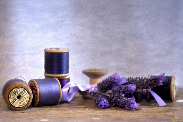 Coils of thread of beautiful lavender color with a sprig of lavender