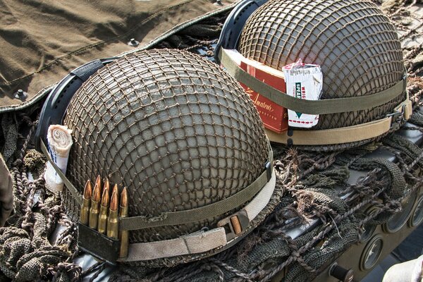 Two army helmets and a soldier s kit