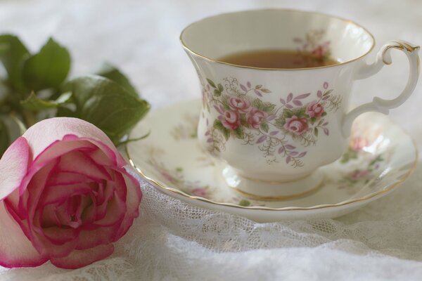 Still life with an image of a flower and a cup of tea