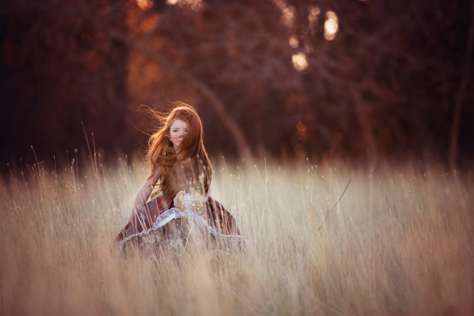 girl red hair wind the field