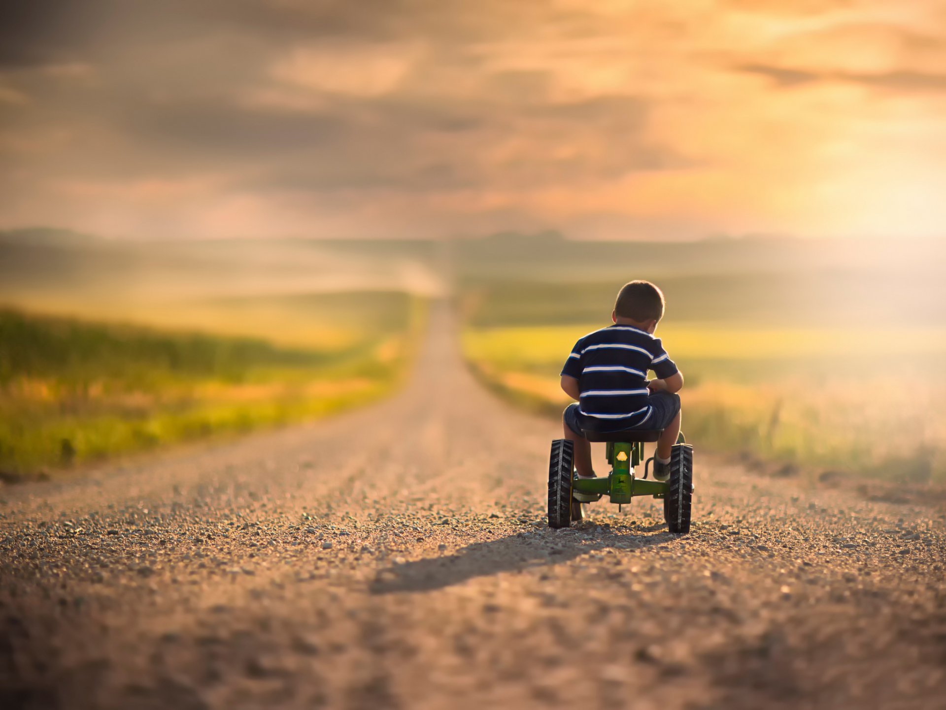 niño bicicleta carretera espacio bokeh