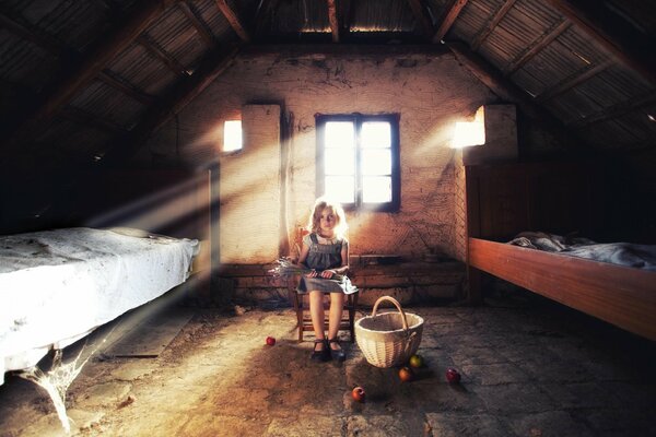 Mädchen sitzt auf dem Dachboden mit einem Korb