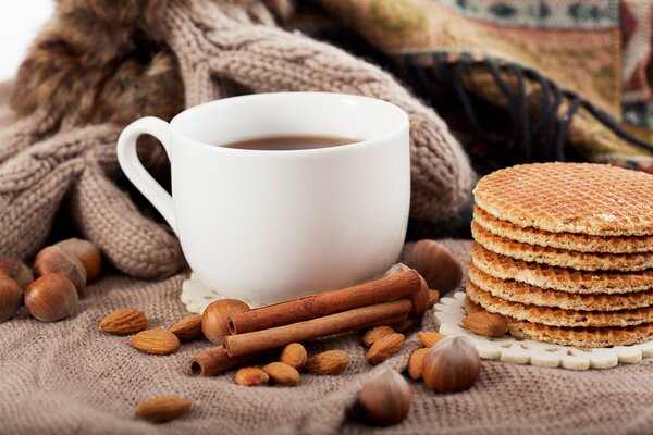 A cup of coffee and cinnamon, waffles are very appetizing!!!