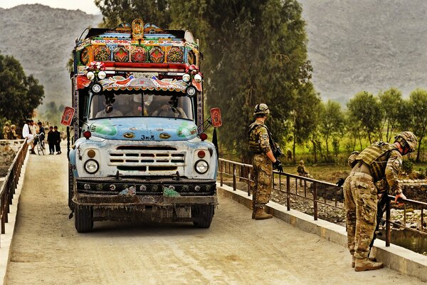 Zil rides on the bridge past the military