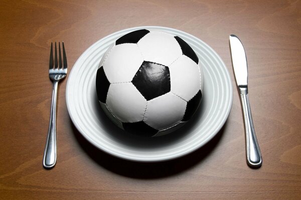 A ball in a white plate and cutlery