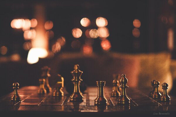 Chessboard and figures in semi-darkness