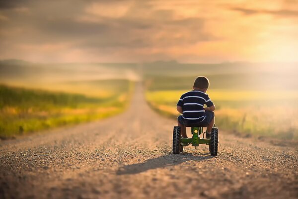 A little boy rides a bicycle