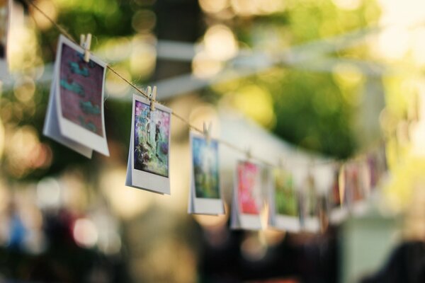 Photos hang on a rope on clothespins