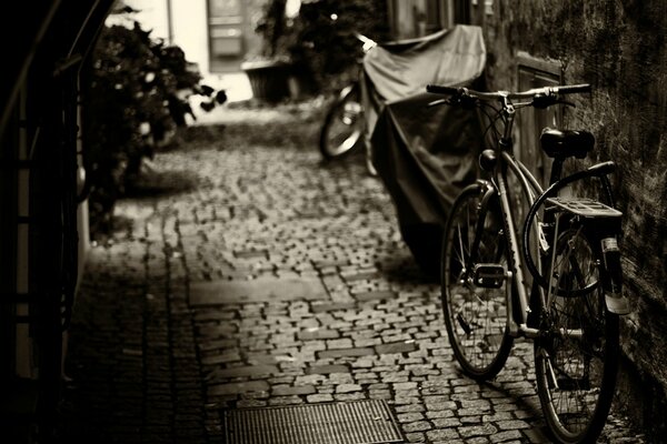 Black and white image of a street with bicycles