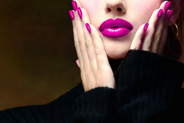 A combination of purple lipstick and nail polish