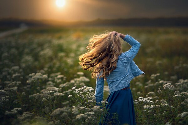 A girl in a field in the bright sun