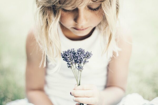 A little girl with a bouquet of flowers