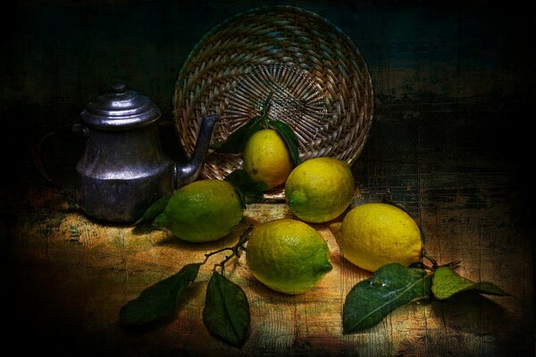 Still life on the table with a teapot, a wicker plate and lemons