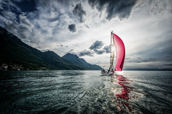 A boat with scarlet sails catches a wave