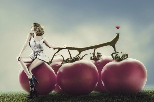 Little girl on big tomatoes