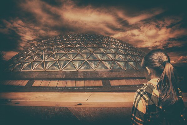 A girl on the background of a gloomy stormy sky