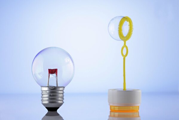 A light bulb with a base and a soap bubble