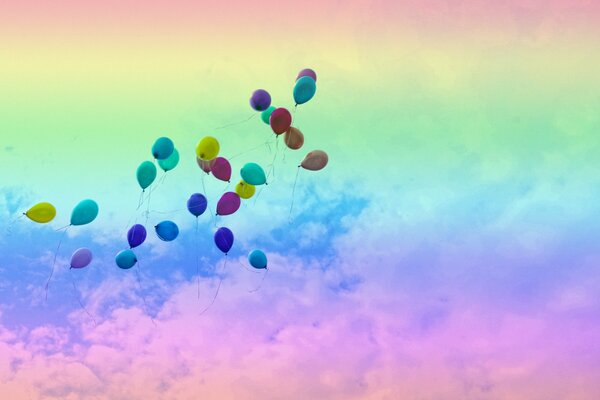 Sur un fond arc-en-ciel, des ballons volent