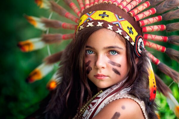 Portrait of a little girl in an Indian warrior costume